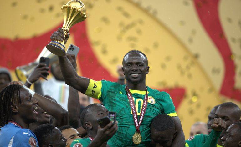 Sadio Mane lifting the AFCON