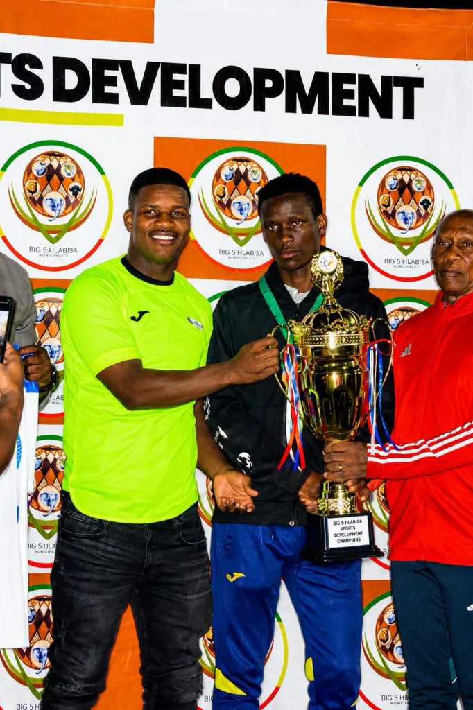 Mbekezeli Mbokazi holding a trophy in Umkhanyakude